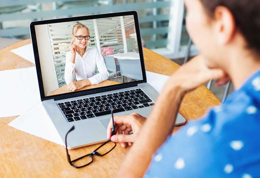 Online interview through video chat on laptop